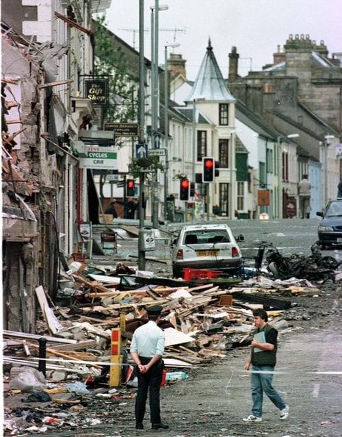 At 3.10pm on Saturday 15 August 1998, a car bomb planted by the Real IRA exploded next to a clothes shop in Omagh, Co Tyrone. Pictured in the aftermath is an RUC officer looking on at the damage from the explosion on Market Street