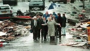 Minister John McFall (centre right) and Deputy Prime Minister John Prescott (centre) walk through the debris of bombed shops in the town centre of Omagh the day after the blast