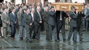 Michael Grimes, husband of grandmother Mary Grimes who was killed in the blast, and family members walk behind her remains being carried by sons and family at her funeral in Beragh, Tyrone