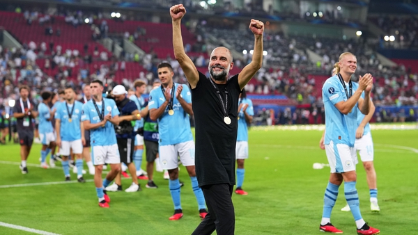 Pep Guardiola celebrates with his Manchester City team in Athens