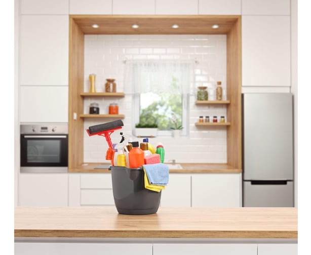 Bucket of cleaning supplies on kitchen work surface