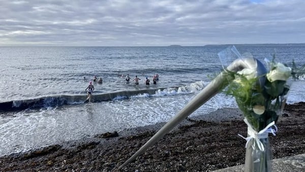 Flowers were placed following a vigil for two men who died during the 2023 event in Youghal.