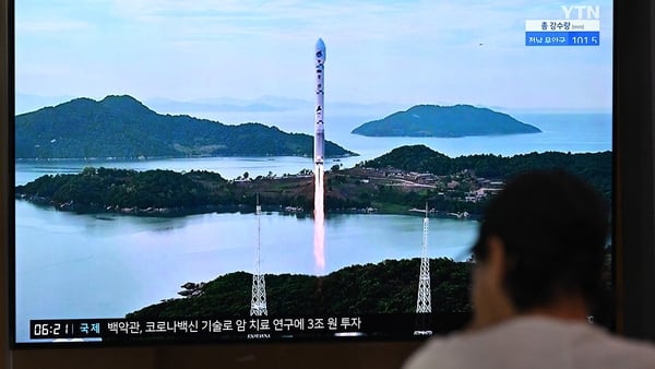 A TV screen in a Seoul, South Korea, train station showing file footage of a North Korean satellite-carrying rocket launch