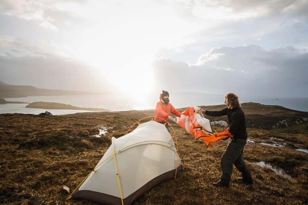 Putting up a tent in bad weather