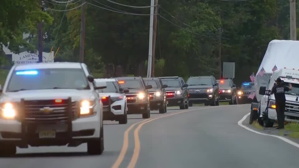 A motorcade carrying Mr Trump leaves Bedminster ahead of his surrender
