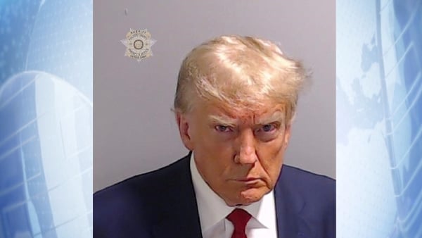 An unsmiling Donald Trump - inmate n. P01135809, according to Fulton County Jail records - was captured glaring at the camera in the mug shot