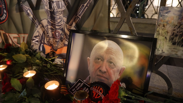 Portraits of Wagner Group founders Yevgeny Prigozhin (R) and Dmitry Utkin (L) seen among candles at an informal memorial for PMC Wagner Group at Varvarka street near the Kremlin on August 24, 2023 in Moscow, Russia. Photo: Getty Images