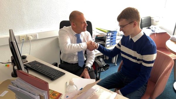 School principal Pádhraic Gibbons congratulates Michael on his LCA results.