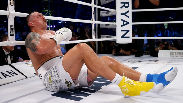 Oleksandr Usyk reacts after being knocked down by Daniel Dubois