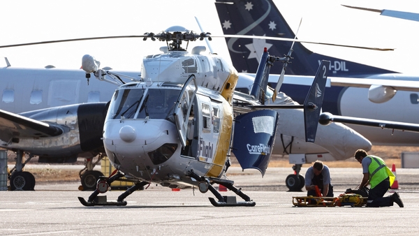 Rescue workers at Darwin International Airport getting ready to transport people injured in the aircraft crash