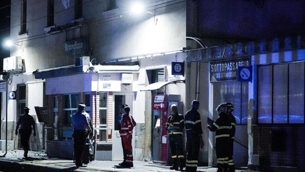 Emergency service workers at the train station in Brandizzo, near where the deaths occurred