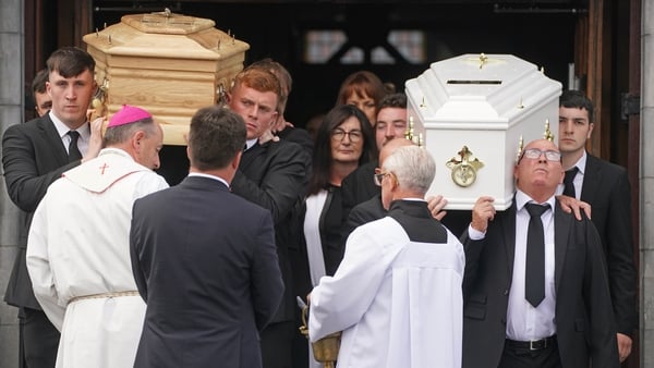 The coffins of Grace and Luke McSweeney leave the church after the service