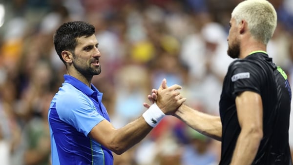 Novak Djokovic embraces Borna Gojo following their match