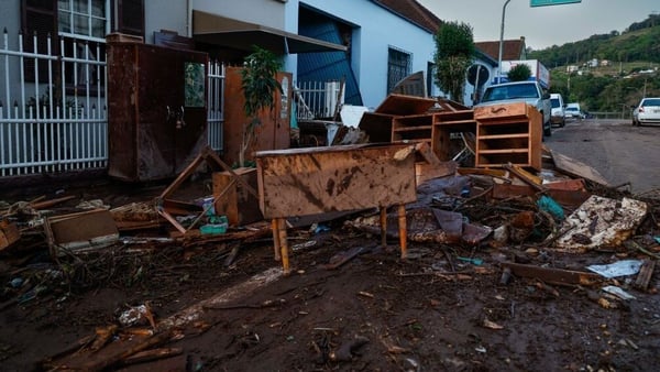 Furniture covered in mud outside a house affected by floods in Colinas