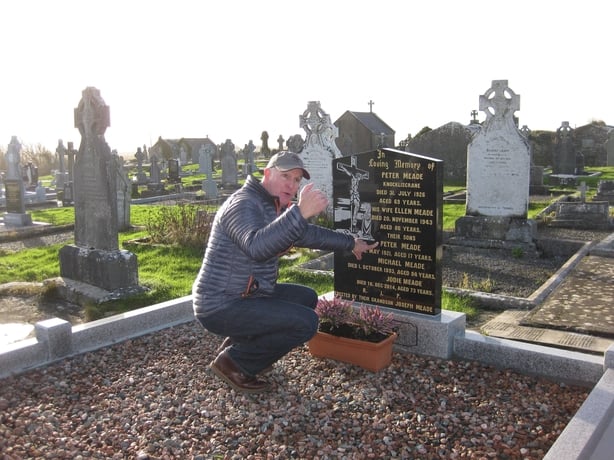 Man standing at a grave