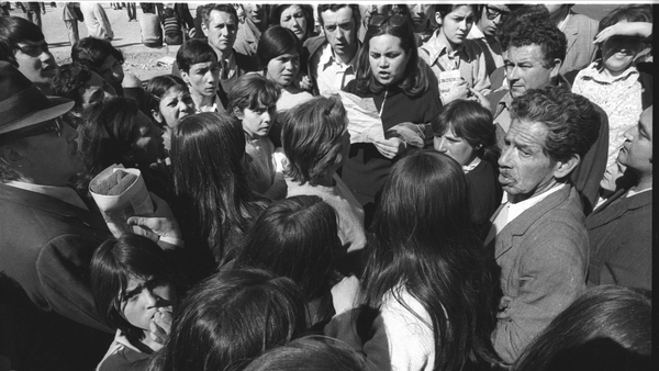 A woman reads aloud a list of detainees at National Soccer Stadium to relatives of missing persons in the days after Pinochet's military coup in Chile in 1973. Photo: Horacio Villalobos/Corbis via Getty Images