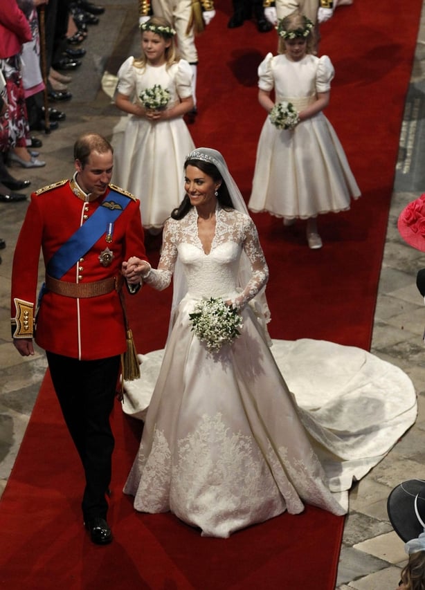 Britain's Prince William (L) and Catherine, Duchess of Cambridge, walk up the aisle after their wedding ceremony in Westminster Abbey