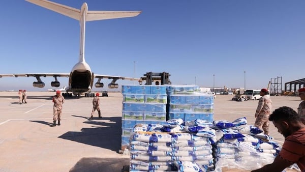 Military personnel supervise the arrival of aid supplied by the UAE for survivors of the floods