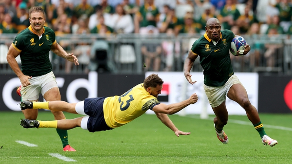 Makazole Mapimpi, one of two South African players to score hat-tricks, breaks past Romania's Gabriel Pop for his third try of the game