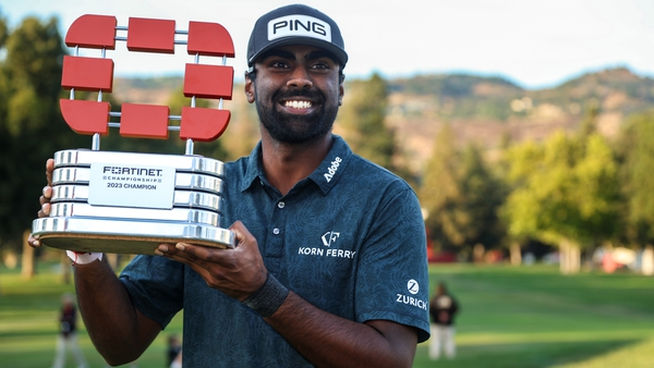 Sahith Theegala raises the trophy following his first win on the Tour