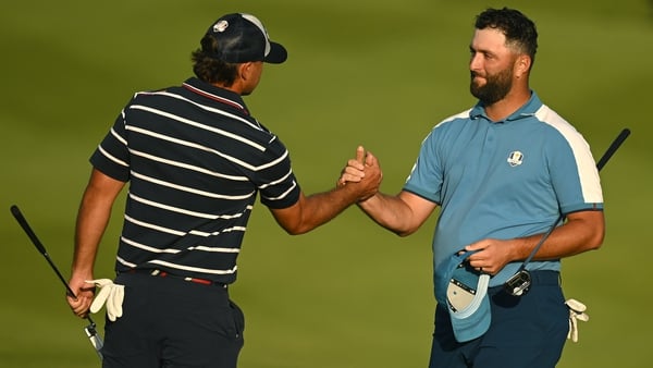 Brooks Koepka shakes hands with Jon Rahm following their fourball match on Friday
