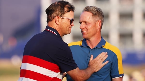 European captain Luke Donald, right, is congratulated by his US counterpart Zach Johnson