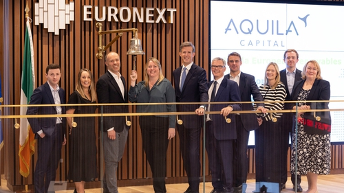 Ian Nolan, Non-Executive Chair of Aquila European Renewables and his teams ring the bell during a ceremony with Niall Jones, Head of Listing, Ireland & UK, Euronext