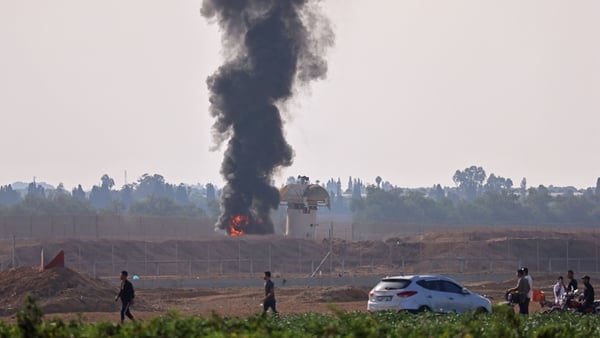 A picture taken from Khan Yunis in southern Gaza shows smoke billowing next to an Israeli observation tower