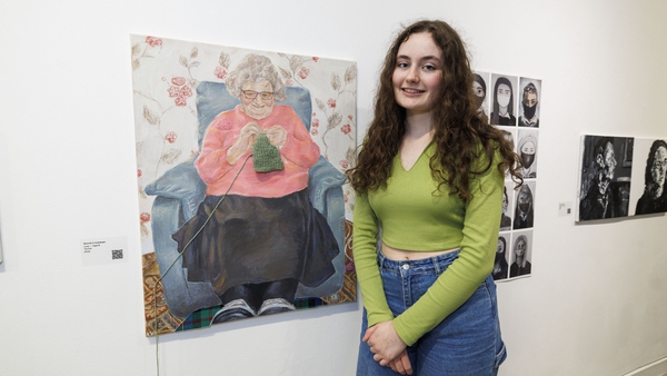 Lucy Young (19) from Omagh with her painting of her grandmother at the This is Art! exhibition