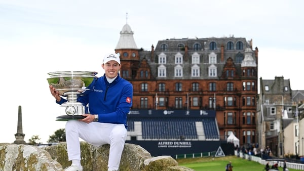 Matt Fitzpatrick of England poses with the trophy on the Swilcan Bridge at St Andrew's
