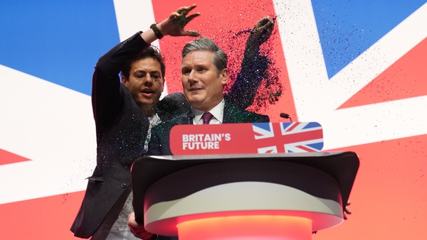 The man throws glitter on Labour leader Keir Starmer as he begins his conference speech