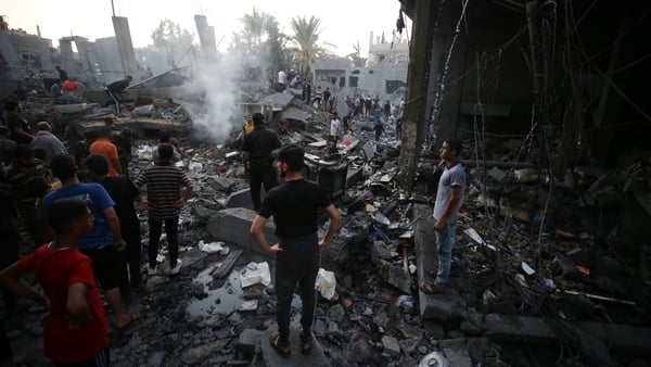 An overview of destroyed buildings as people gather to search for victims following an Israeli airstrike on Deir al-Balah, central Gaza