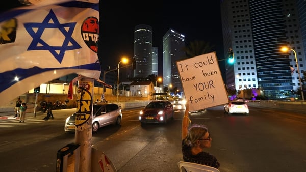 A demonstrator in Tel Aviv carries a placard during a demonstration calling for the release of Israeli hostages held by Hamas since 7 October