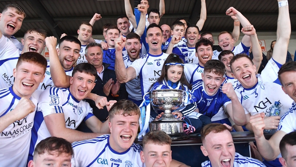 Naas captain Eoin Doyle, 6, celebrates with team-mates and the Dermot Bourke cup after his side's victory