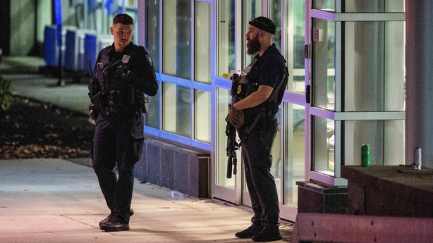 Armed law enforcement officials guard the ambulance entrance to the Central Maine Medical Center in Lewiston