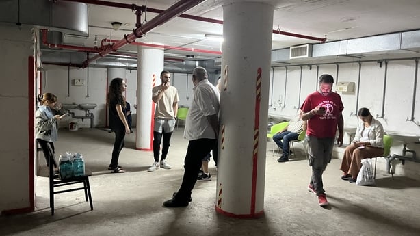 Israelis wait out in a bomb shelter in Tel Aviv 