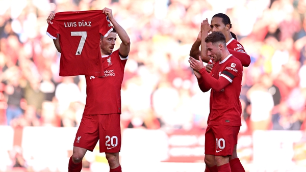 Liverpool striker Diogo Jota holds a shirt in support of Luis Diaz last Sunday