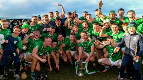 O'Loughlin Gaels players celebrate with the Tom Walsh Cup