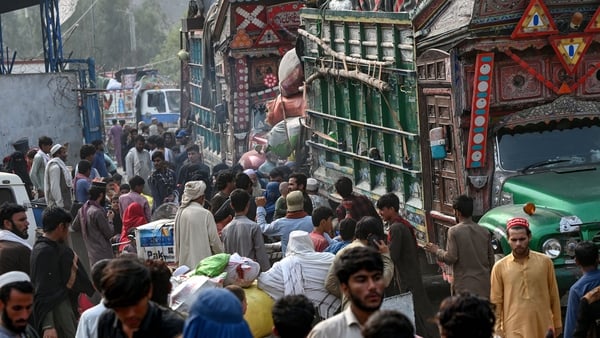 Afghan refugees arrive in trucks from Pakistan at the Afghanistan-Pakistan Torkham border crossing