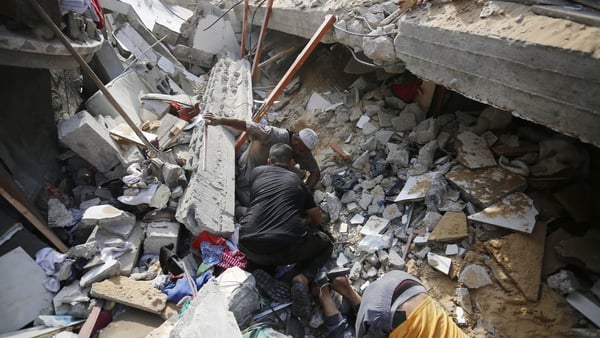 Palestinians conduct a search and rescue operation after an Israeli attack on the Maghazi refugee camp in Gaza City