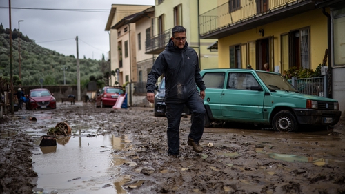 A man walks in the mud in Montemurlo, near Prato, in Tuscany