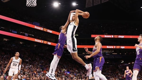 Victor Wembanyama attempts to dunk during the victory over the Phoenix Suns