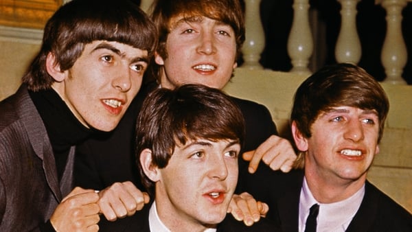 The Beatles smiling together. From left to right: George Harrison, John Lennon (top), Paul McCartney (bottom), and Ringo Starr. Pictured in 1964. Photo: Getty Images