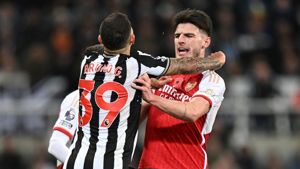Newcastle's Bruno Guimaraes (L) clashes with Arsenal's Declan Rice