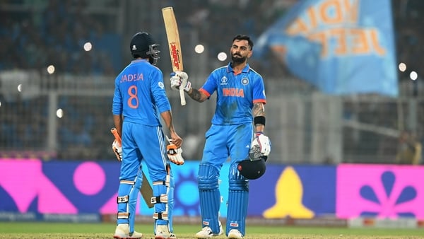 Virat Kohli celebrates his historic century alongside team-mate Ravi Jadeja