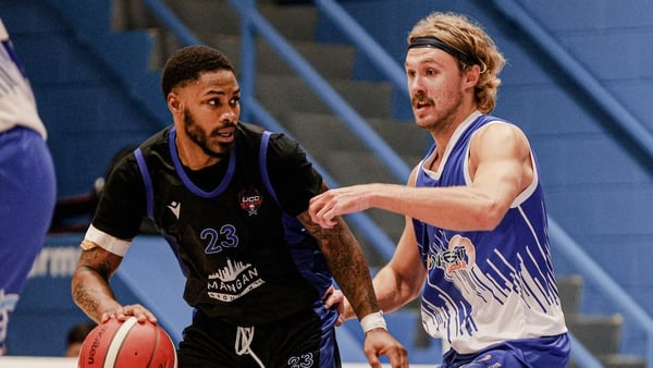 UCC Blue Demons' Seventh Woods is challenged by Tom Dumont of Maree