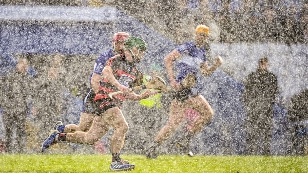 Ballygunner's Conor Sheehan is pursued by Daniel Kearney of Sarsfields in heavy rain at Walsh Park