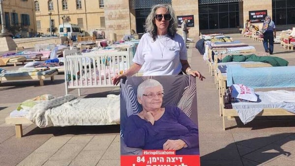 Neta Heiman Mina with a poster of her mother Ditza