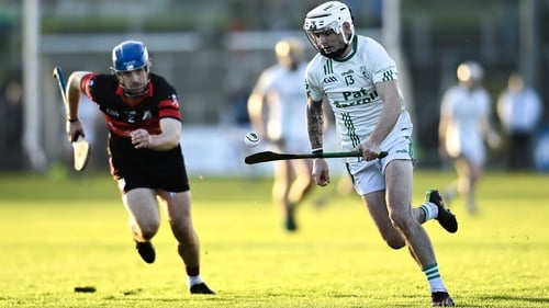 Owen Wall of O'Loughlin Gaels is pursued by Mount Leinster Rangers' Michael Doyle