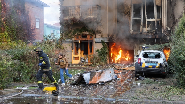 Firefighters extinguish a fire after Russian artillery shelling of Kherson city centre